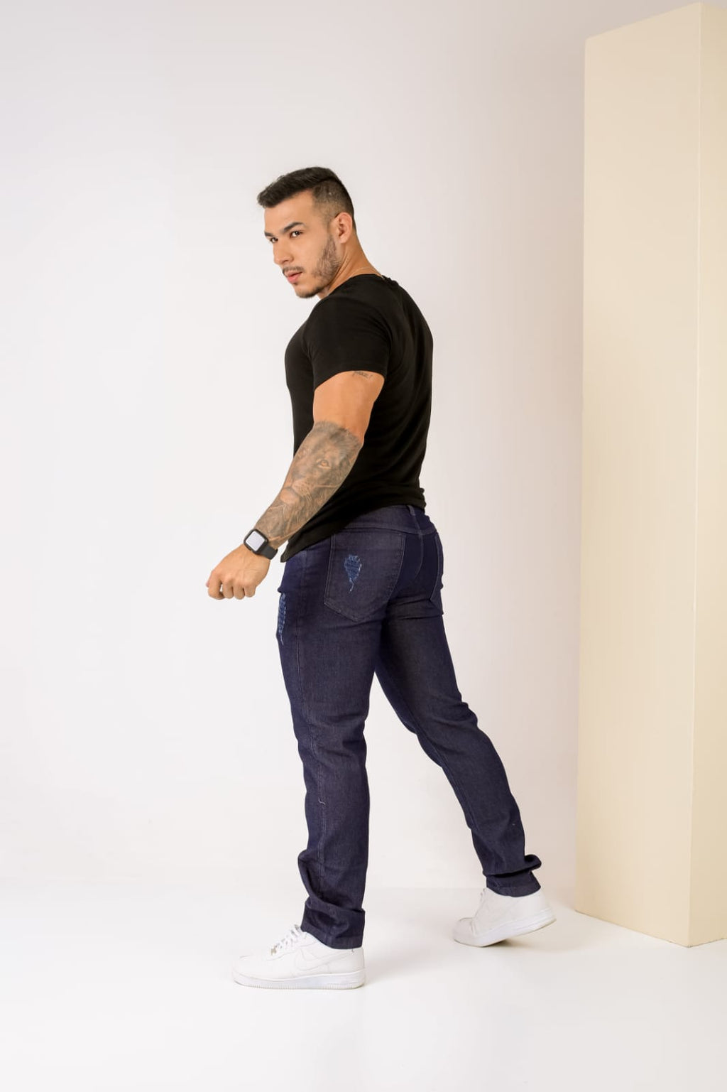 Calça de sarja slim masculina escura com detalhe no bolso traseiro em relevo